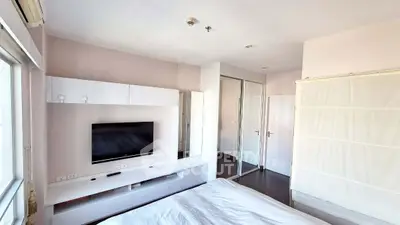 Modern bedroom with sleek design and built-in TV unit