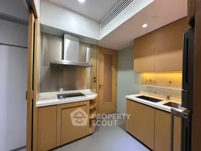 Modern kitchen with sleek cabinetry and built-in appliances in a contemporary apartment.