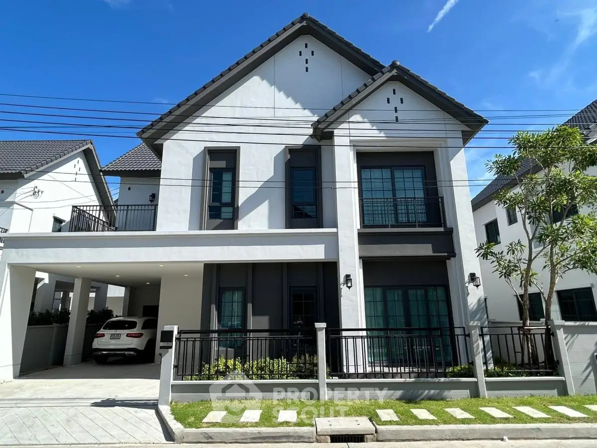 Stunning modern two-story house with sleek design and spacious driveway in a serene neighborhood.