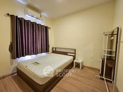 Spacious bedroom with modern furnishings and natural light, perfect for comfortable living.