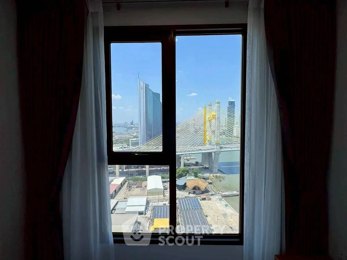 Stunning cityscape view from a modern apartment window, showcasing urban architecture and a vibrant skyline.