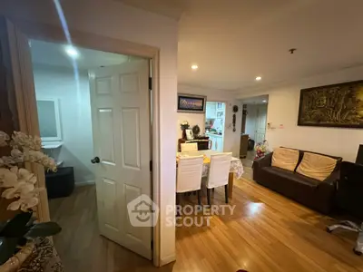 Charming open-layout living and dining area with wooden flooring and cozy decor.