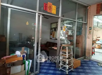 Commercial space with glass partitions and blue tiled floor, ideal for office or retail setup.