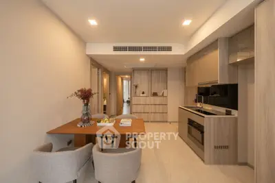 Modern kitchen with open layout and dining area in elegant apartment
