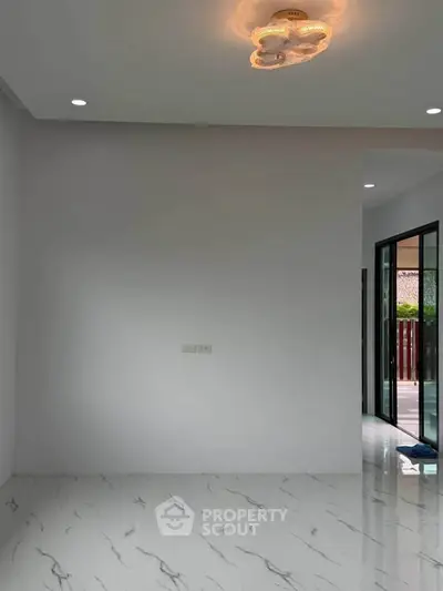 Spacious modern interior with marble flooring and stylish lighting, perfect for contemporary living.