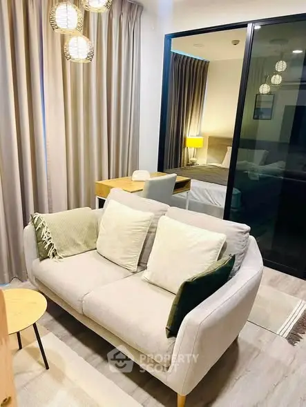 Modern living room with cozy sofa and stylish decor in a contemporary apartment.