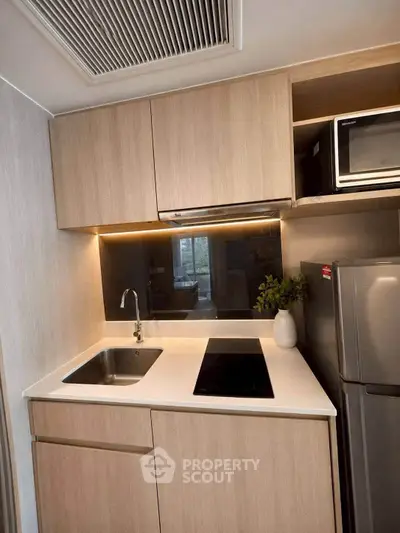 Modern kitchen with sleek cabinetry and built-in appliances, perfect for urban living.