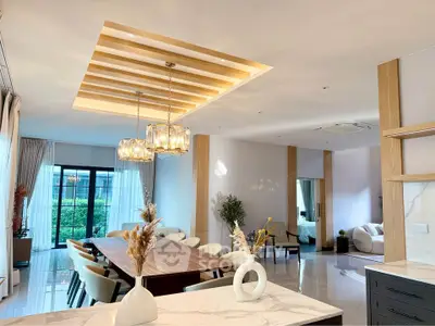 Luxurious open-plan living and dining area with modern decor and natural light.