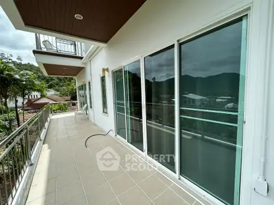 Spacious balcony with scenic mountain views and modern glass doors