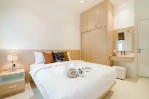 Modern bedroom with cozy decor and built-in wardrobe in a stylish apartment.