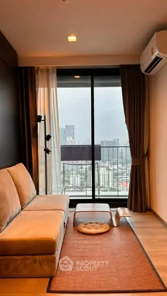 Modern living room with city view, cozy sofa, and stylish decor in high-rise apartment.