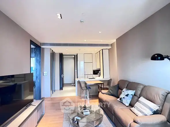Modern living room with stylish decor and open kitchen layout in a contemporary apartment.