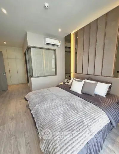 Luxurious modern bedroom with stylish decor and ample natural light