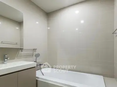Modern bathroom with sleek bathtub and elegant tile design