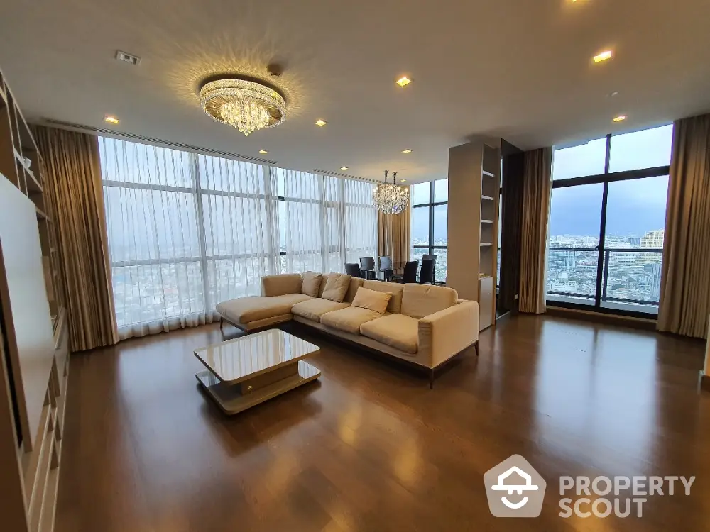 Luxurious living room with panoramic city views and elegant chandelier