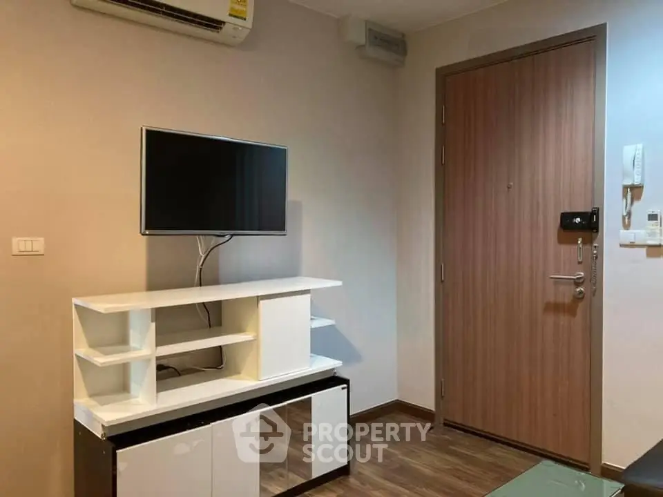 Modern living room with wall-mounted TV and stylish wooden door