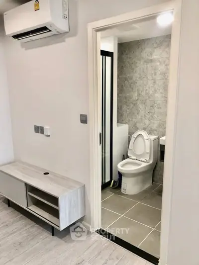 Modern apartment interior with compact bathroom and sleek design
