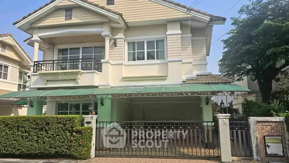 Charming two-story house with a spacious front yard and gated entrance in a serene neighborhood.