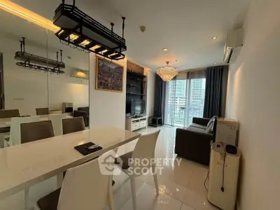 Modern living room with elegant chandelier and city view balcony