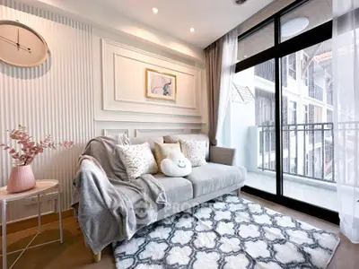 Stylish living room with cozy sofa and large balcony view in modern apartment.