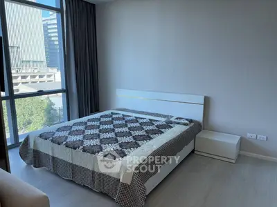 Modern bedroom with large window and city view, featuring a stylish bed and minimalist decor.