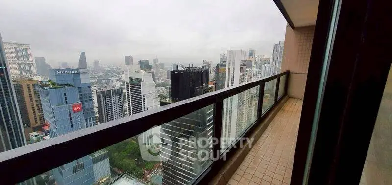 Stunning cityscape view from high-rise balcony in urban setting.