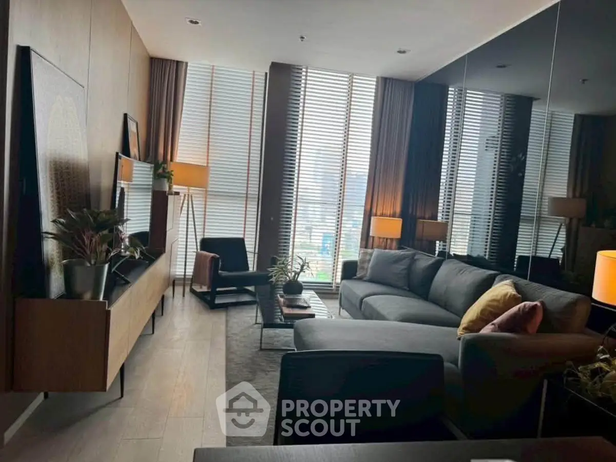 Luxurious modern living room with floor-to-ceiling windows and stylish decor