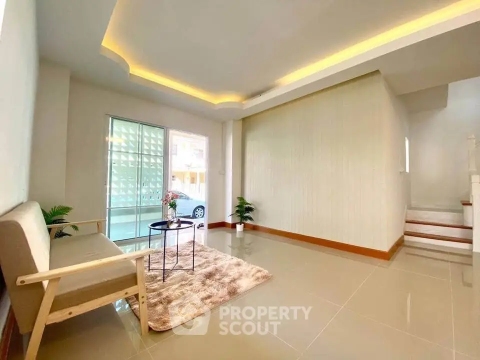 Spacious modern living room with elegant lighting and cozy seating area.