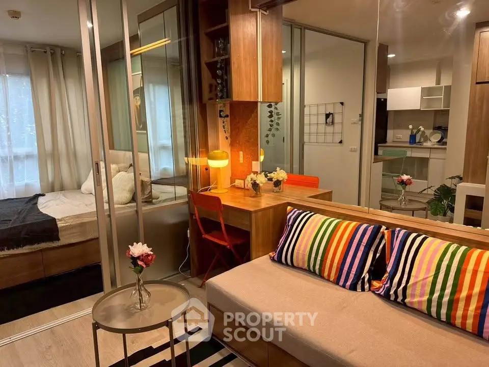 Chic modern apartment with colorful decor and open layout, featuring cozy living area and stylish bedroom.