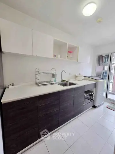 Modern kitchen with sleek cabinetry and ample counter space in a bright, airy setting.