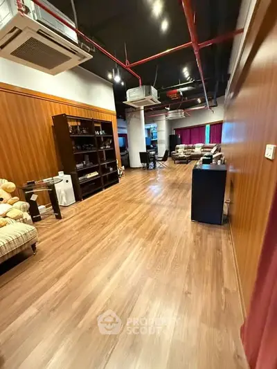 Spacious modern living room with wooden flooring and stylish furniture