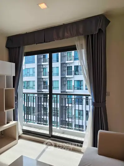 Modern living room with large window and balcony view in urban apartment