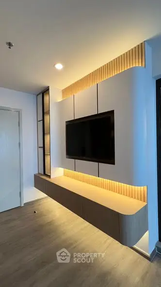 Modern living room with sleek TV wall unit and ambient lighting