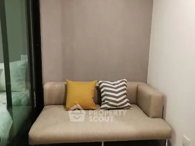 Cozy small living room with modern beige sofa and colorful cushions