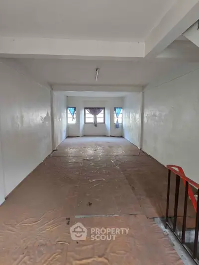 Spacious interior with large windows and natural light, ideal for versatile use.