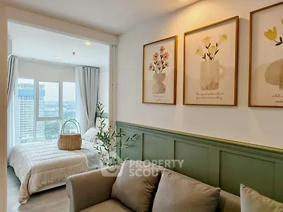 Charming living room with cozy decor and a view into a bright bedroom, perfect for modern urban living.