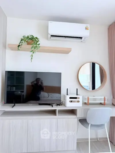 Modern study area with TV, air conditioner, and stylish decor