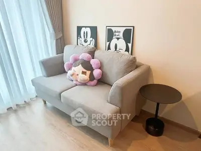 Cozy living room with stylish sofa and playful decor, perfect for relaxation.