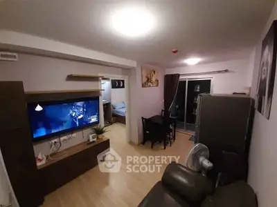 Cozy living room with modern decor and open layout leading to a bedroom, perfect for urban living.