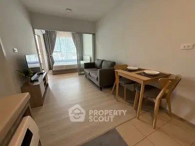 Modern compact living room with dining area and bedroom view