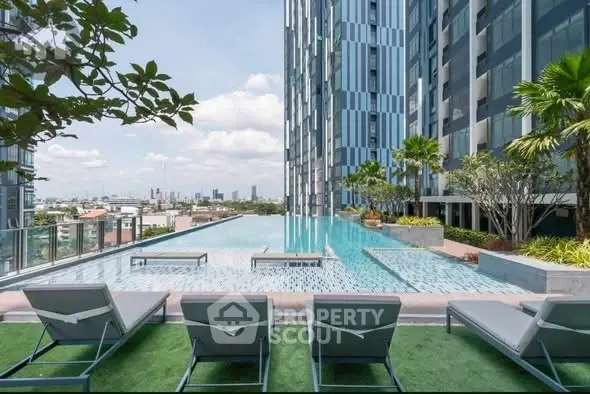 Luxurious rooftop pool with stunning city views in modern high-rise building.