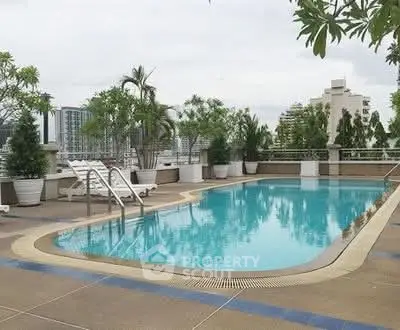 Luxurious rooftop pool with city skyline views and lush greenery.