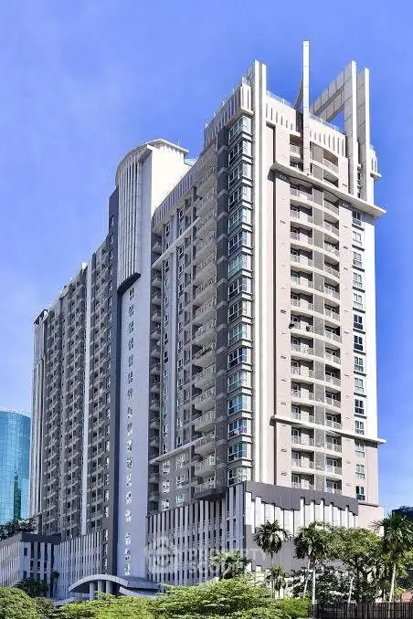 Stunning high-rise residential building with modern architecture and lush greenery.