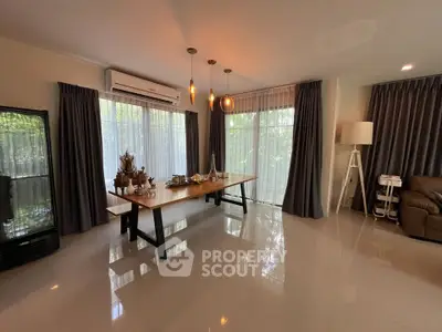 Spacious living room with modern decor and large windows offering natural light.
