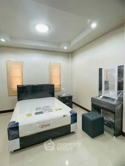 Modern bedroom with stylish furniture and natural lighting, perfect for a cozy retreat.