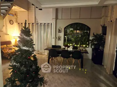 Cozy living room with Christmas tree and modern dining area