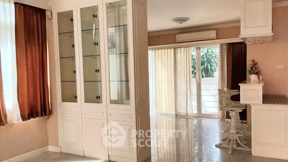 Spacious living area with elegant cabinetry and natural light, perfect for modern living.