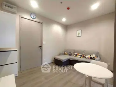Cozy living room with modern decor and comfortable seating in a stylish apartment.