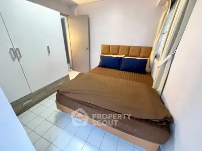 Cozy bedroom with modern wardrobe and large bed in a stylish apartment.