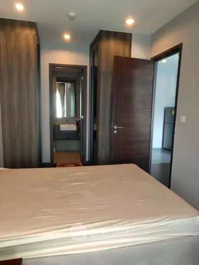 Modern bedroom with ensuite bathroom and sleek wooden accents